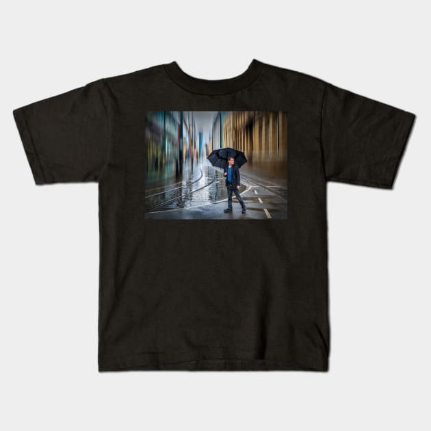 Man with Umbrella in Rainy City Kids T-Shirt by TonyNorth